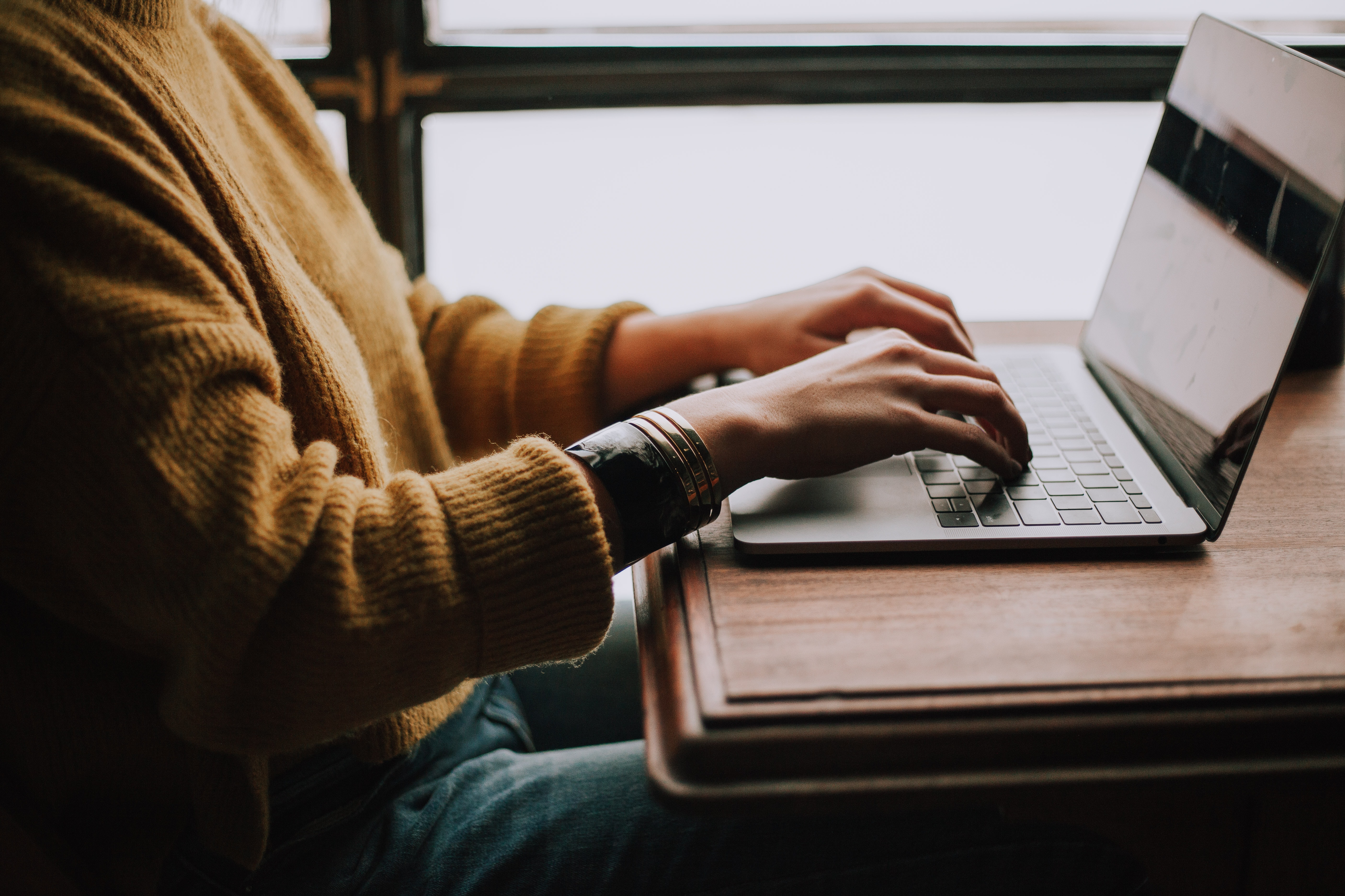 A person typing on a laptop