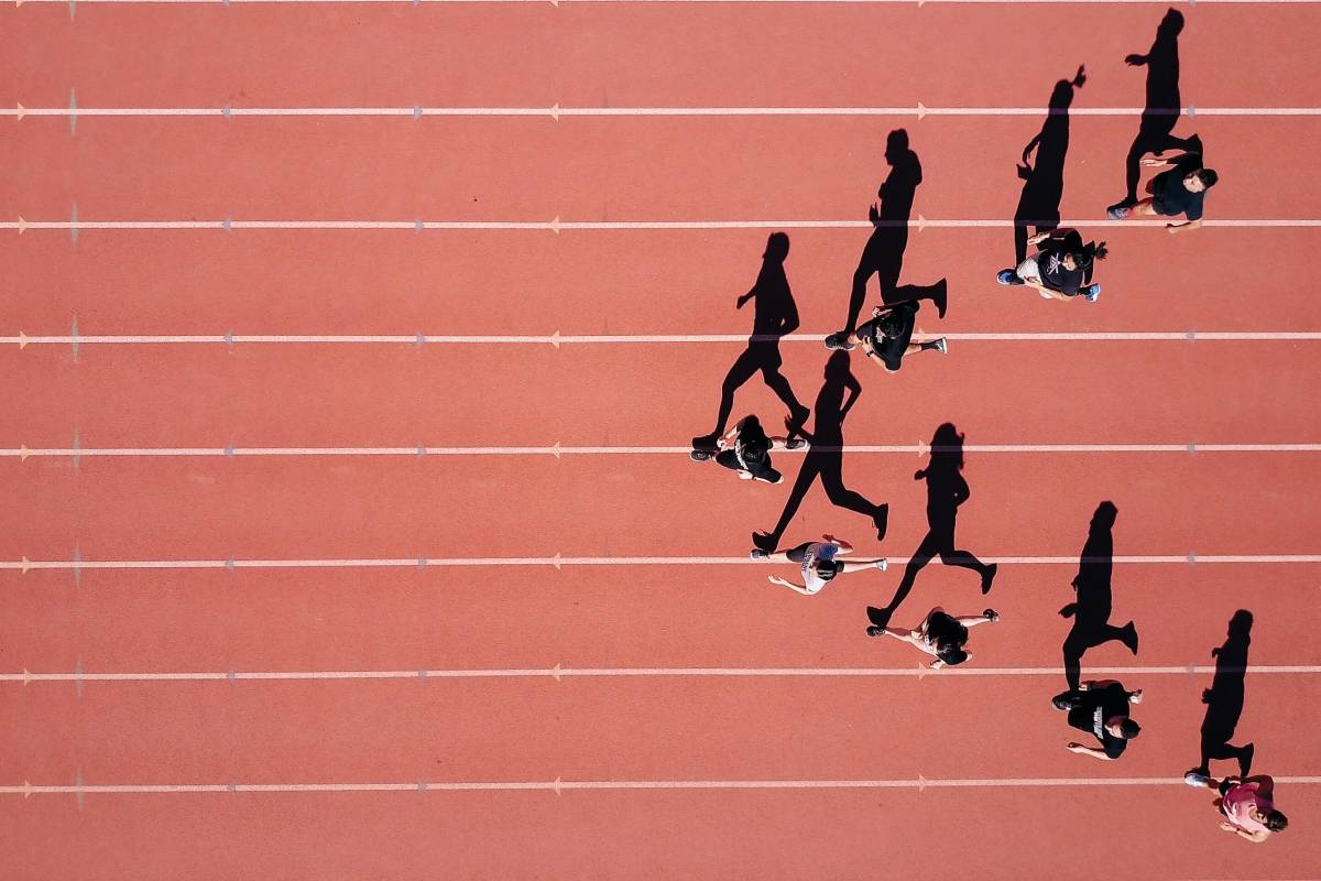Runners on a track seen from above
