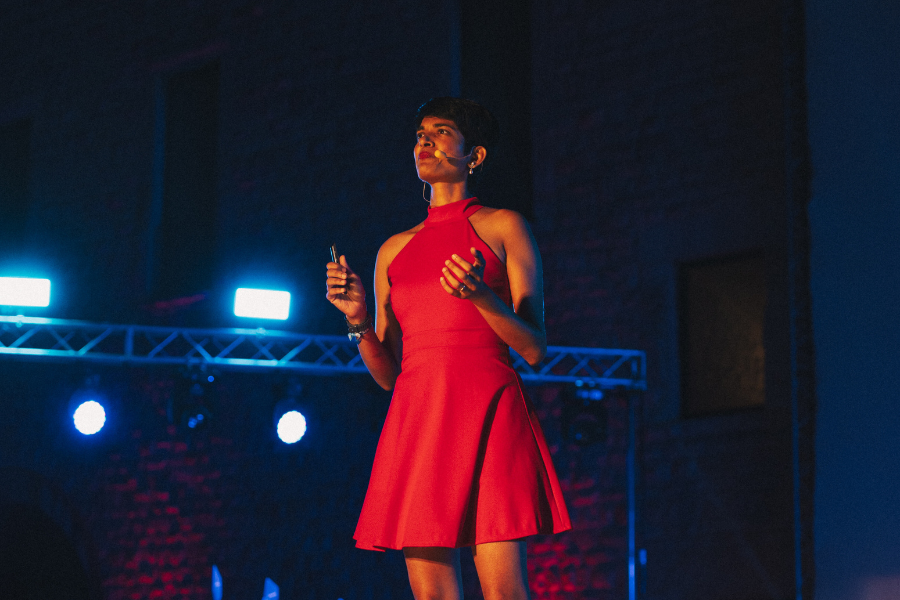 Shalini Kurapati speaking on the stage at TEDx Barletta