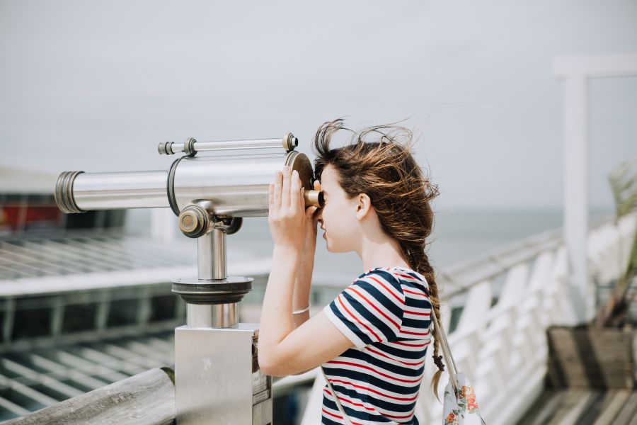 A girl looking in a telescope